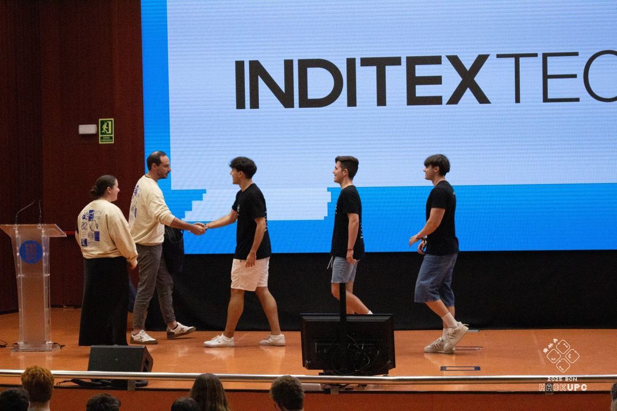 The Echolook team walking on stage to collect the InditexTech first prize at HackUPC 2025